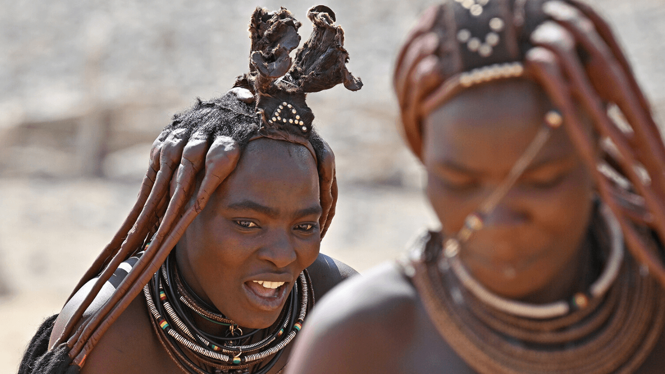 Close-up of two Himba women showcasing their traditional hairstyles.